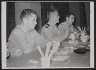 Photograph of three Air Force ROTC cadets eating